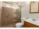 Bright bathroom with tiled shower, toilet, and vanity with wood cabinets at 2936 E Willetta St, Phoenix, AZ 85008