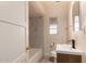 Updated bathroom features modern vanity, mirror and shower over tub at 2936 E Willetta St, Phoenix, AZ 85008