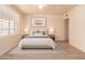 Bright bedroom with neutral tones featuring a large window, wood-look floors, and stylish decor at 2936 E Willetta St, Phoenix, AZ 85008