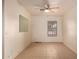 Bedroom featuring tile flooring, a ceiling fan, and a bright window for natural light at 2936 E Willetta St, Phoenix, AZ 85008