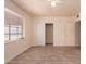 Bedroom featuring tile flooring, large window, and spacious closet at 2936 E Willetta St, Phoenix, AZ 85008