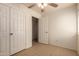 Bedroom with tile floor, ceiling fan, and double door closet at 2936 E Willetta St, Phoenix, AZ 85008