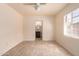 Bright bedroom featuring a ceiling fan, large window, and en suite bathroom at 2936 E Willetta St, Phoenix, AZ 85008