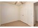 Bedroom featuring tile floors, a ceiling fan, and a double door closet for storage at 2936 E Willetta St, Phoenix, AZ 85008