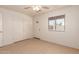 Bedroom featuring tile floors, a ceiling fan, and a double door closet for storage at 2936 E Willetta St, Phoenix, AZ 85008