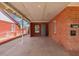 Attached carport area with brick exterior and concrete floor, providing covered parking at 2936 E Willetta St, Phoenix, AZ 85008