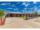 Street view of a charming home with a long driveway, carport, and well-kept yard at 2936 E Willetta St, Phoenix, AZ 85008