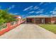 Exterior view of the home showcasing the front yard, carport, and red brick construction at 2936 E Willetta St, Phoenix, AZ 85008