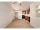Open kitchen featuring tile floors, white appliances, and wood cabinets at 2936 E Willetta St, Phoenix, AZ 85008
