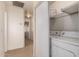 Laundry area in hallway with washer, dryer, and shelving for storage at 2936 E Willetta St, Phoenix, AZ 85008
