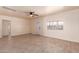 Inviting living room with a ceiling fan, large windows, and neutral tile flooring at 2936 E Willetta St, Phoenix, AZ 85008