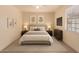 Well-lit main bedroom with neutral colors, bedside tables, and a dresser to create a cozy personal space at 2936 E Willetta St, Phoenix, AZ 85008