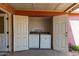 Covered patio featuring laundry room with washer and dryer behind double doors at 2936 E Willetta St, Phoenix, AZ 85008