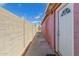 Narrow side yard features privacy fence and leads to back door at 2936 E Willetta St, Phoenix, AZ 85008