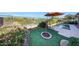 Backyard oasis with lush landscaping, charming accents, and a serene pool for relaxation at 29749 N 130Th Dr, Peoria, AZ 85383