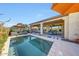 Enjoy this private outdoor living with covered patio, pool, lush greenery, and serene desert views at 29749 N 130Th Dr, Peoria, AZ 85383