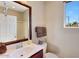 Bathroom with a vanity, a large mirror, and a window with a view to the outside at 29749 N 130Th Dr, Peoria, AZ 85383