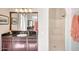 Well-lit bathroom featuring a granite countertop, vanity, mirror and a step-in shower with glass door at 29749 N 130Th Dr, Peoria, AZ 85383
