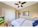 Comfortable bedroom features neutral tones, ceiling fan, and large closet at 29749 N 130Th Dr, Peoria, AZ 85383