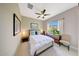 Cozy bedroom with a ceiling fan, a window with natural light, and warm decor at 29749 N 130Th Dr, Peoria, AZ 85383