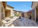 Private courtyard with seating, a fountain feature, and desert landscaping creates a relaxing outdoor space at 29749 N 130Th Dr, Peoria, AZ 85383