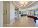 Grand entryway with a tray ceiling, tile floors, and an adjacent formal living and dining area at 29749 N 130Th Dr, Peoria, AZ 85383