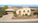 Charming single-story home boasts a well-maintained front yard, a two-car garage, and solar panels at 29749 N 130Th Dr, Peoria, AZ 85383