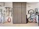 Garage with slat wall and storage cabinet perfect for organizing tools, bikes, and yard equipment at 29749 N 130Th Dr, Peoria, AZ 85383