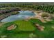 Scenic aerial view of the lush golf course with a tranquil lake and meticulously manicured greens at 29749 N 130Th Dr, Peoria, AZ 85383