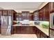Well-equipped kitchen featuring stainless steel appliances, granite countertops, and custom cabinetry at 29749 N 130Th Dr, Peoria, AZ 85383