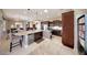 Open kitchen featuring granite counters, an island with seating, and modern appliances at 29749 N 130Th Dr, Peoria, AZ 85383