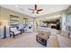 Living room showcases an open floorplan with living area, tile flooring, and kitchen in background at 29749 N 130Th Dr, Peoria, AZ 85383