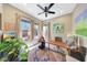 Well-lit home office with large windows, an area rug and a ceiling fan at 29749 N 130Th Dr, Peoria, AZ 85383