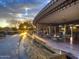 Outdoor restaurant patio featuring modern architecture, a water feature, and picturesque sunset views at 29749 N 130Th Dr, Peoria, AZ 85383