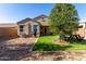 Well-maintained backyard with artificial grass, desert landscaping, a built-in grill, and covered patio for relaxation at 29809 W Columbus Ave, Buckeye, AZ 85396