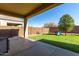 Expansive backyard featuring a covered patio, artificial turf, privacy walls and picnic table at 29809 W Columbus Ave, Buckeye, AZ 85396