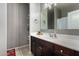 Cozy bathroom with dark cabinets, single sink vanity, and framed mirror at 29809 W Columbus Ave, Buckeye, AZ 85396