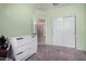 Bright bedroom featuring light green walls, closet and white dresser at 29809 W Columbus Ave, Buckeye, AZ 85396