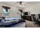 Spacious bedroom featuring a ceiling fan, and a workstation with monitors and gaming chair at 29809 W Columbus Ave, Buckeye, AZ 85396