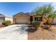 Charming home featuring a two-car garage, desert landscaping, and covered entrance in a modern color palette at 29809 W Columbus Ave, Buckeye, AZ 85396
