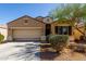 Well-maintained home with low-maintenance desert landscaping, two-car garage, and classic color scheme at 29809 W Columbus Ave, Buckeye, AZ 85396