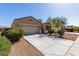 Inviting single Gathering home with a desert landscaped front yard, wide driveway and two-car garage at 29809 W Columbus Ave, Buckeye, AZ 85396