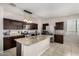 Charming kitchen with stainless steel appliances, granite counters and tile floors for a clean and modern look at 29809 W Columbus Ave, Buckeye, AZ 85396