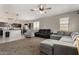 Open concept living room connects to the kitchen with neutral walls, carpet flooring, and an airy feel at 29809 W Columbus Ave, Buckeye, AZ 85396