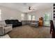 Spacious living room featuring carpet, neutral walls, large windows and a ceiling fan to ensure your comfort at 29809 W Columbus Ave, Buckeye, AZ 85396