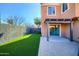 Paver patio and artificial grass create a low-maintenance backyard, complete with a pergola and privacy wall at 2994 E Megan St, Gilbert, AZ 85295