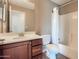 Bright bathroom showcasing a vanity with wood cabinets and a shower-tub combination with a shower curtain at 2994 E Megan St, Gilbert, AZ 85295