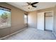 Bedroom with a ceiling fan, natural light from two windows, carpet flooring and a large closet at 2994 E Megan St, Gilbert, AZ 85295