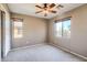 Carpeted bedroom featuring ceiling fan and one window with neighborhood views at 2994 E Megan St, Gilbert, AZ 85295
