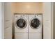 Laundry room featuring two large, white front-load washing machines and dryers at 2994 E Megan St, Gilbert, AZ 85295